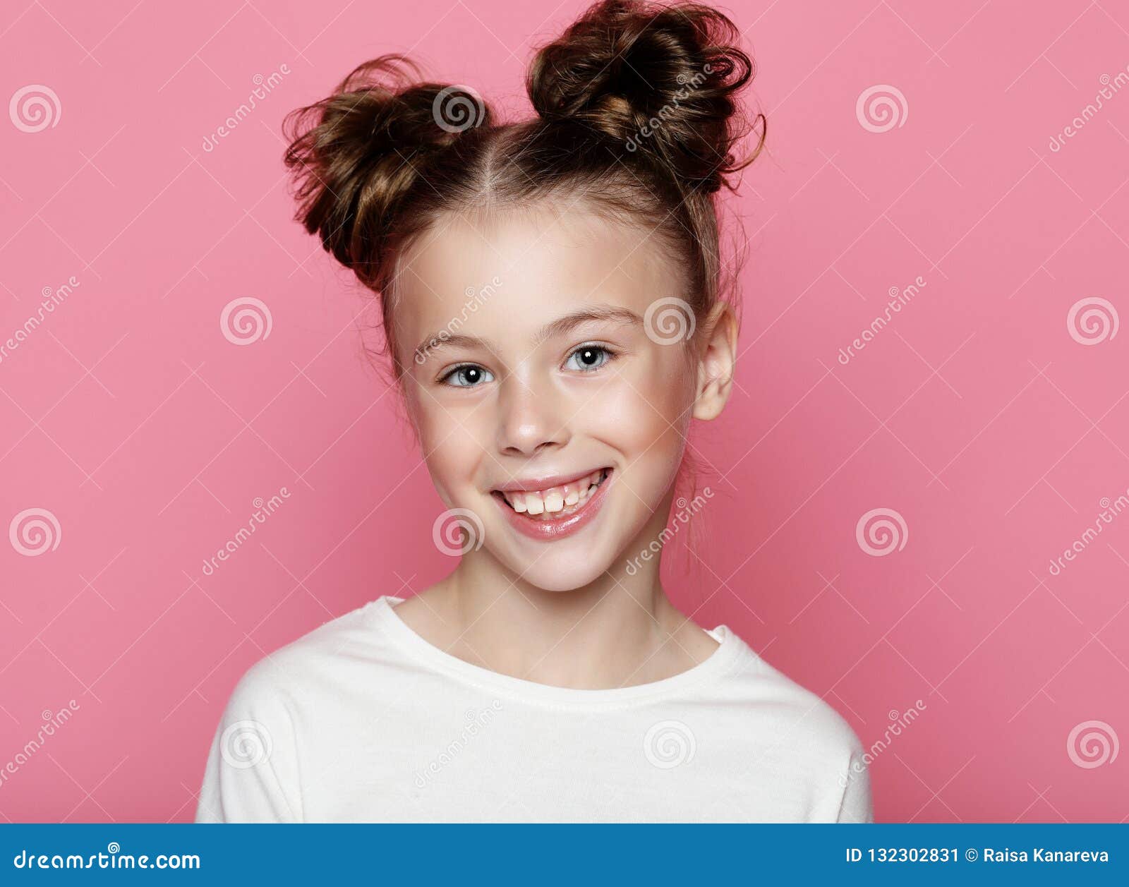 Cute Girl 7-8 Year Old Posing In Studio Over Pink Background Stock