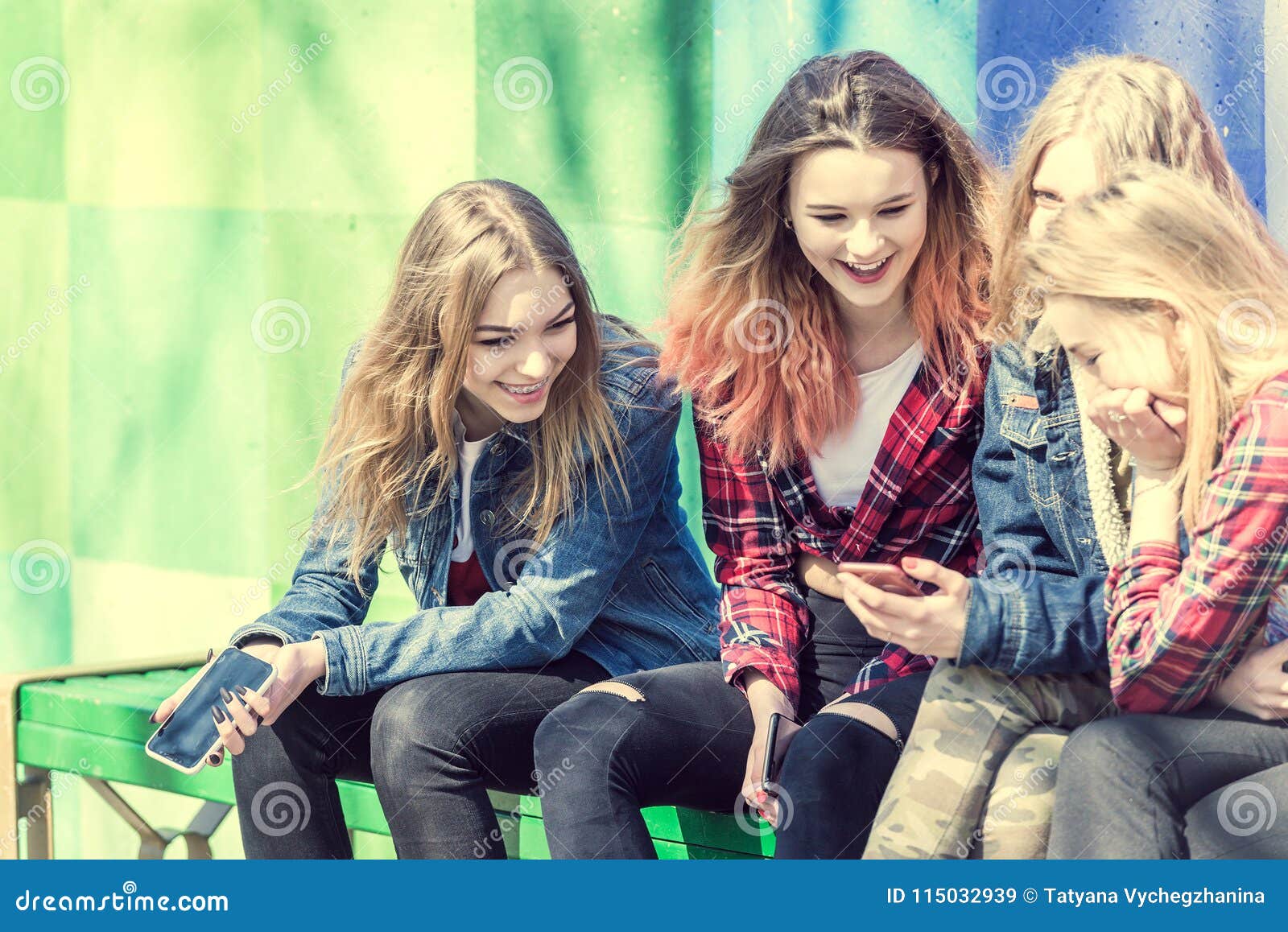 Cute Girls Sitting on the Bench in the Park and Laughing Stock ...