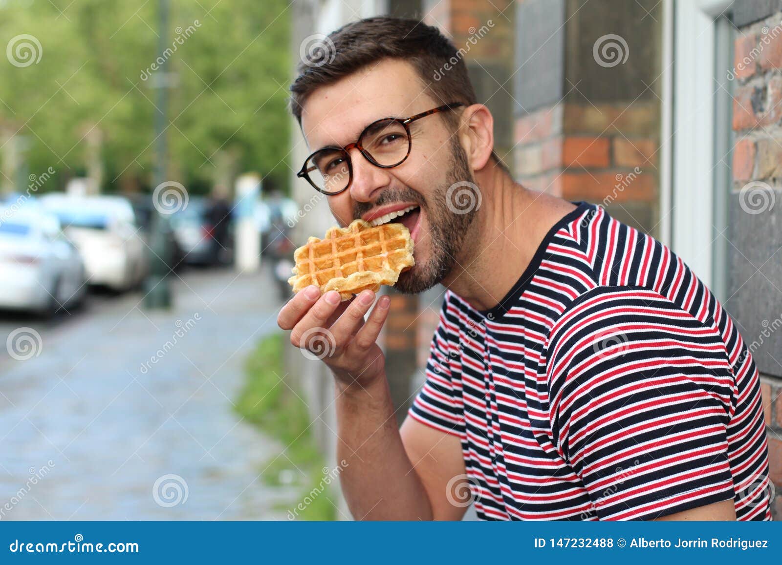 Cute Guy Eating a Waffle in Brussels, Belgium Stock Photo Image of bifocals, candy 147232488