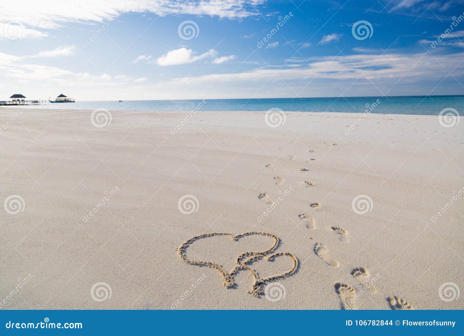 heart  drawing in the sand on tropical beach, romantic and honeymoon concept background for couples