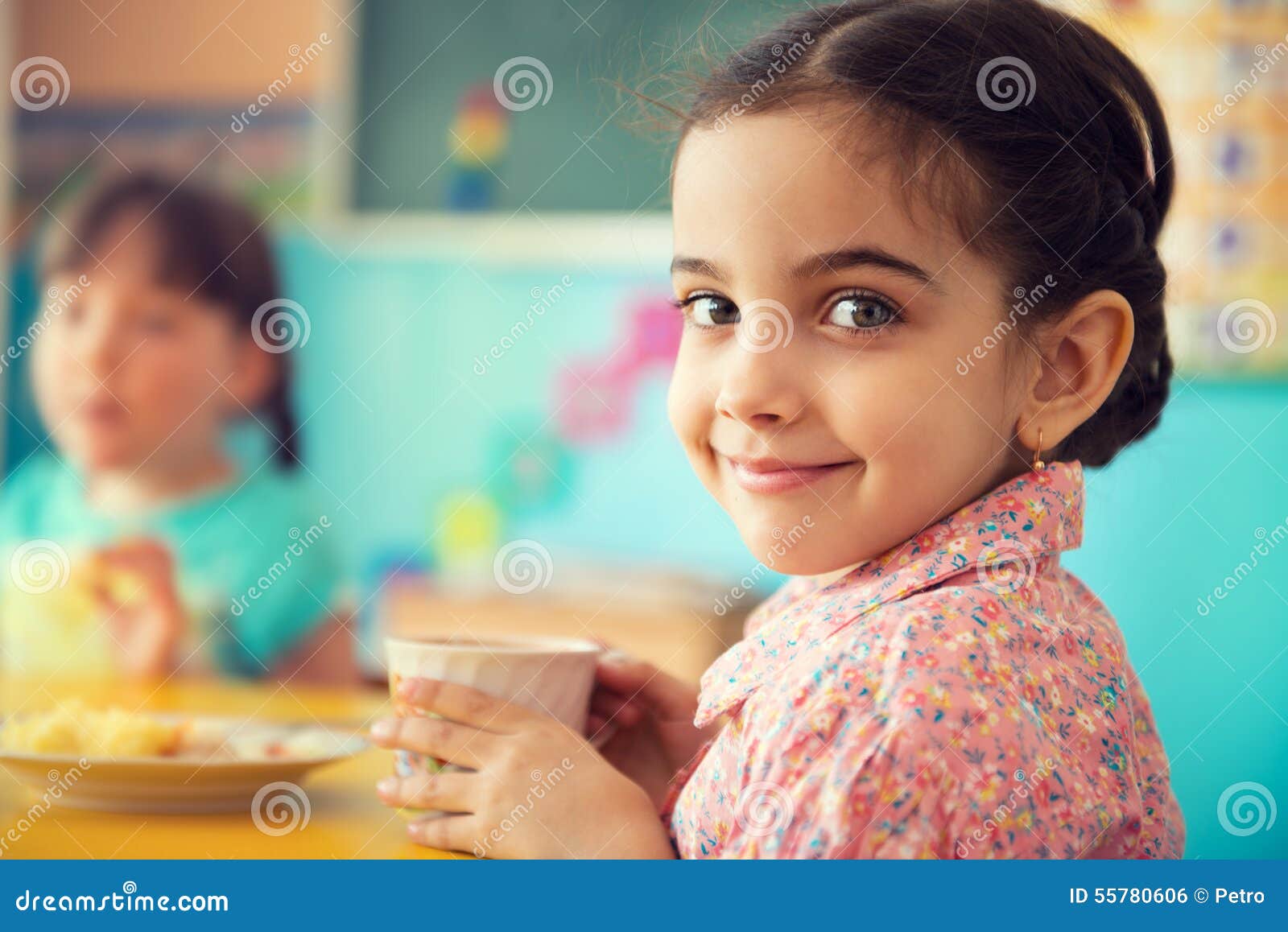 cute hispanic girl drinking milk at school