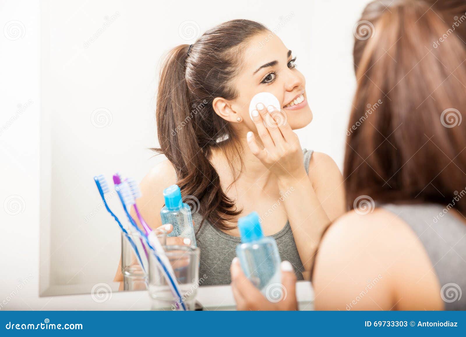 cute hispanic woman removing her makeup