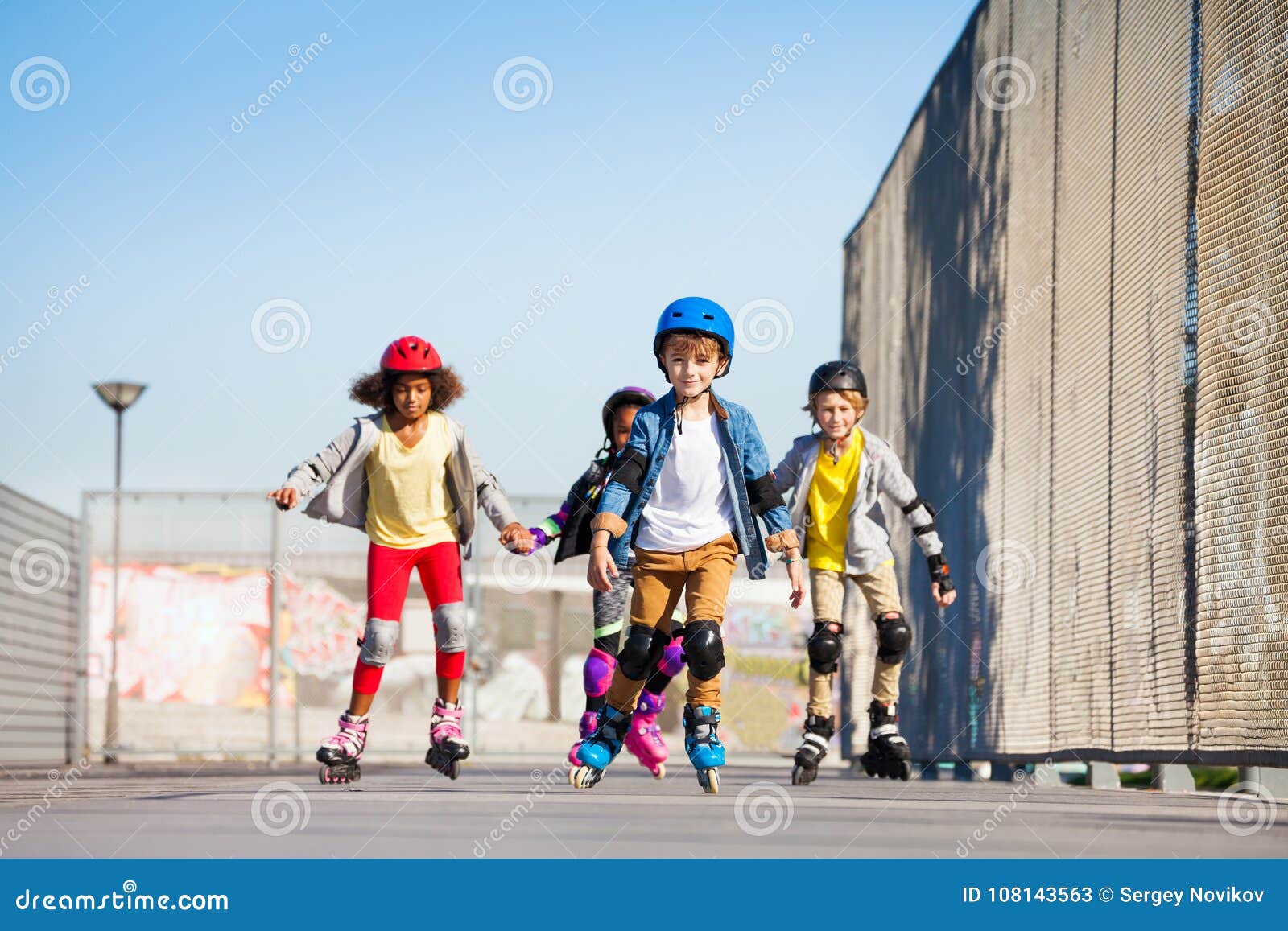 cute kids on roller skates riding outdoors