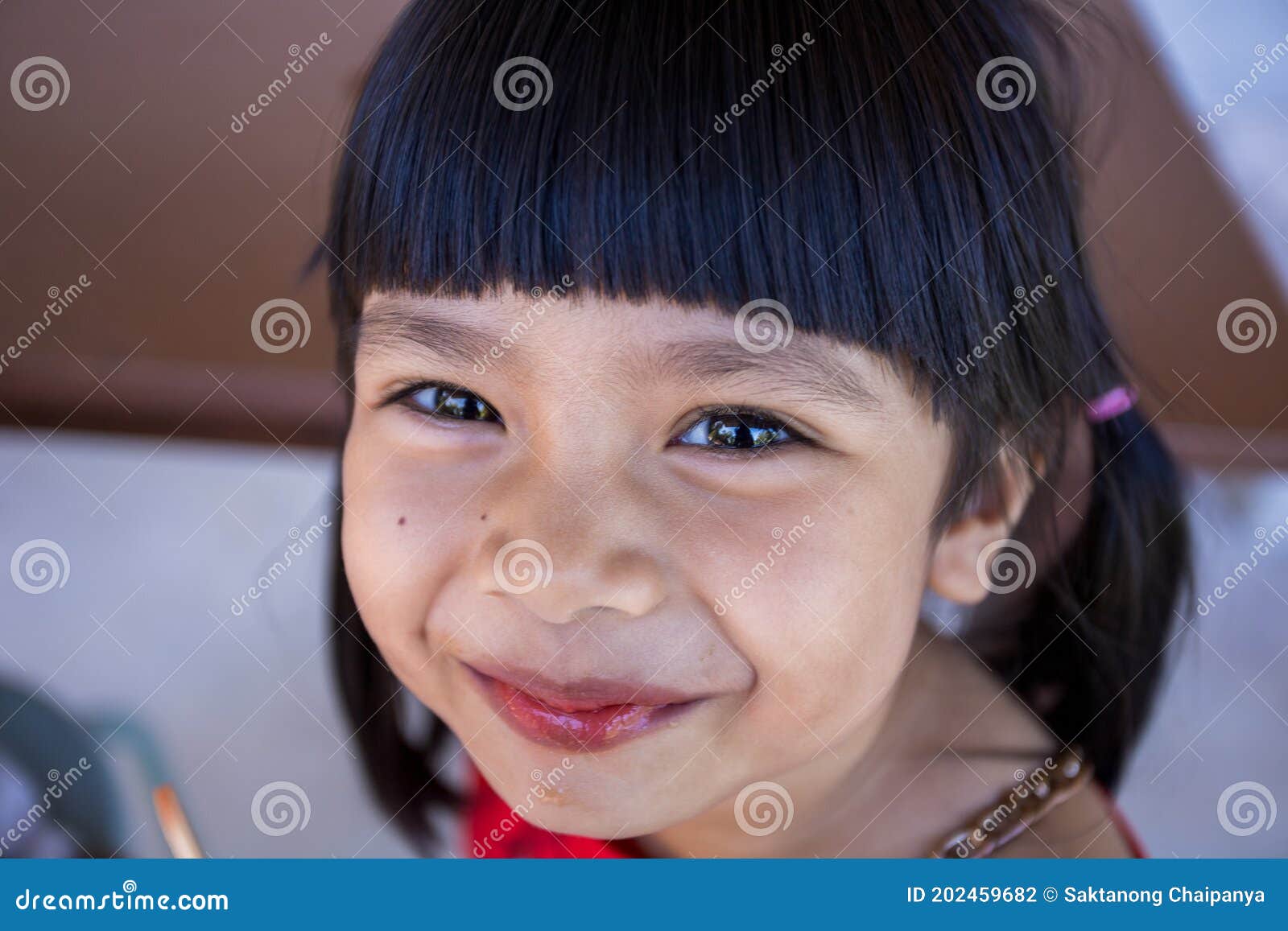 The Cute Little Asian Girl is Happily Eating Ice Cream Stock Photo ...