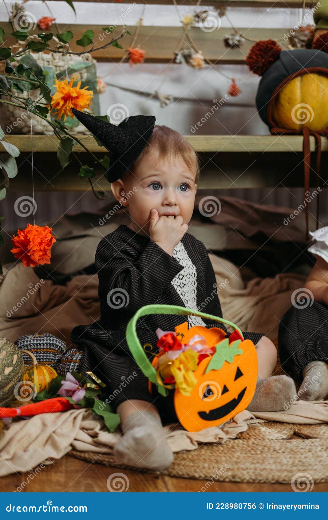 Cute Little Baby Girl Dressed in Halloween Costume Sitting on Bed with ...