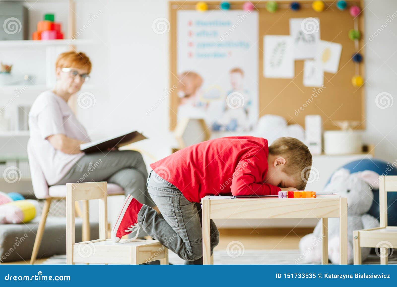 cute little boy with adhd during session with professional therapist