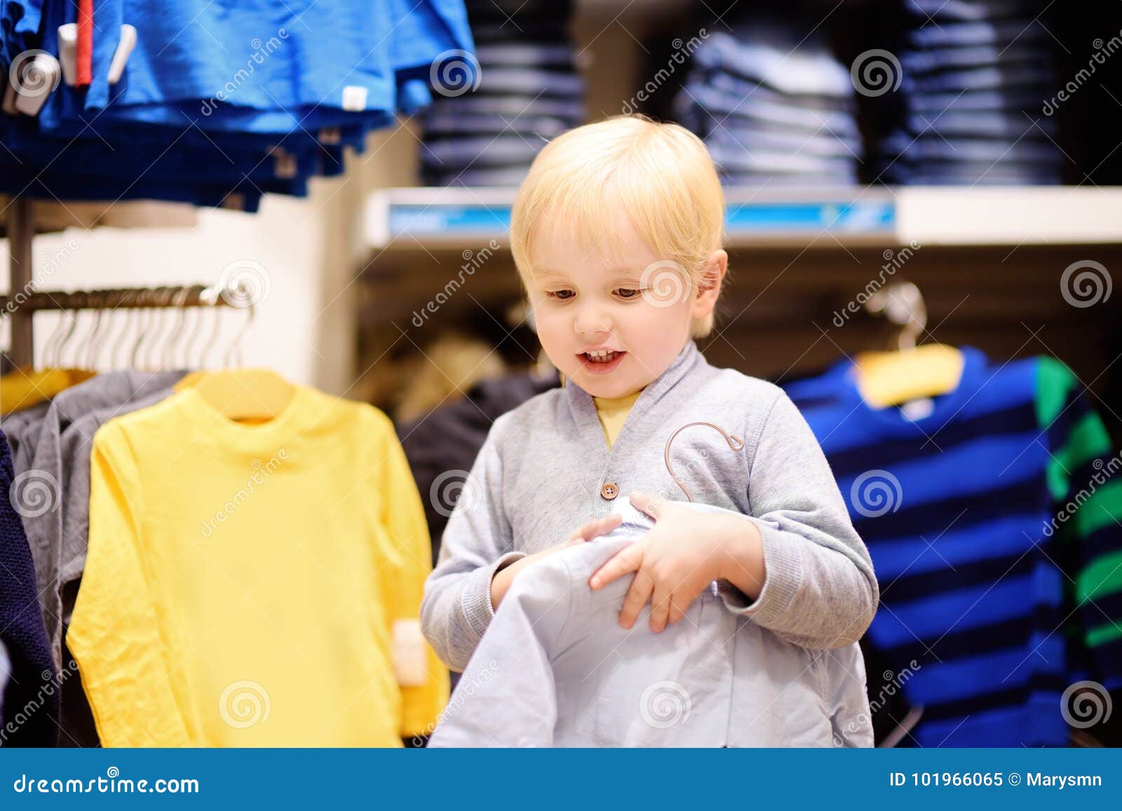 Cute Little Boy Choosing New Clothes during Shopping Stock Image ...