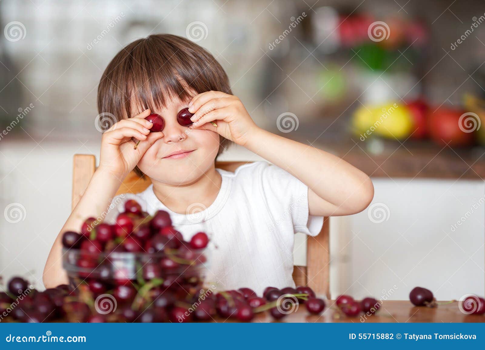 Cute Little Boy, Eating Cherries at Home in the Kitchen, Making Stock