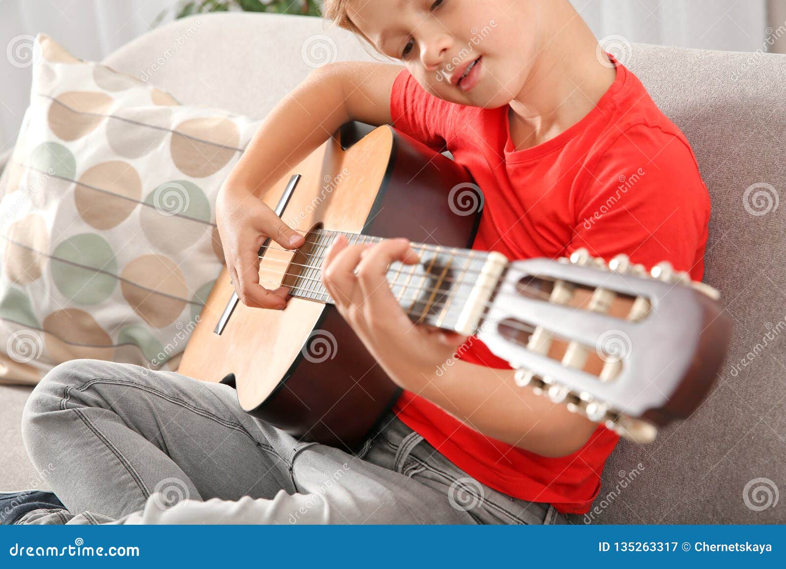 cute boy playing guitar