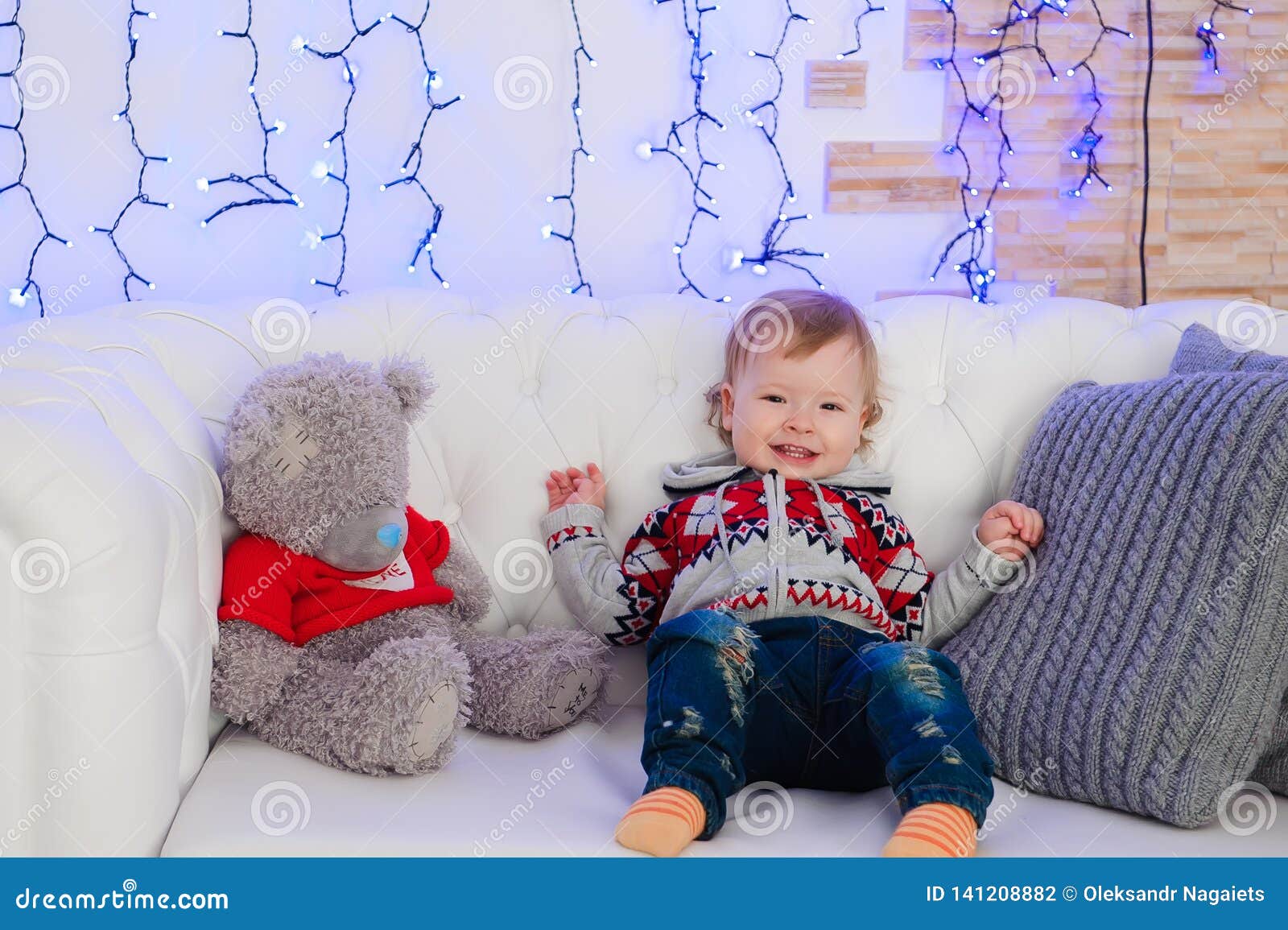 Cute Little Boy is Sitting on the Couch at Home. Stock Photo Image of