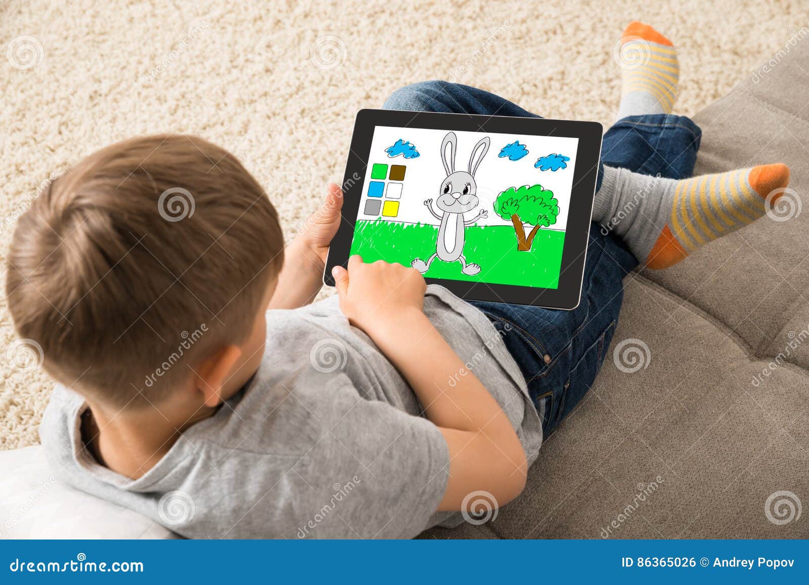 Cute Little Child Playing Game on Digital Tablet Stock Photo - Image of