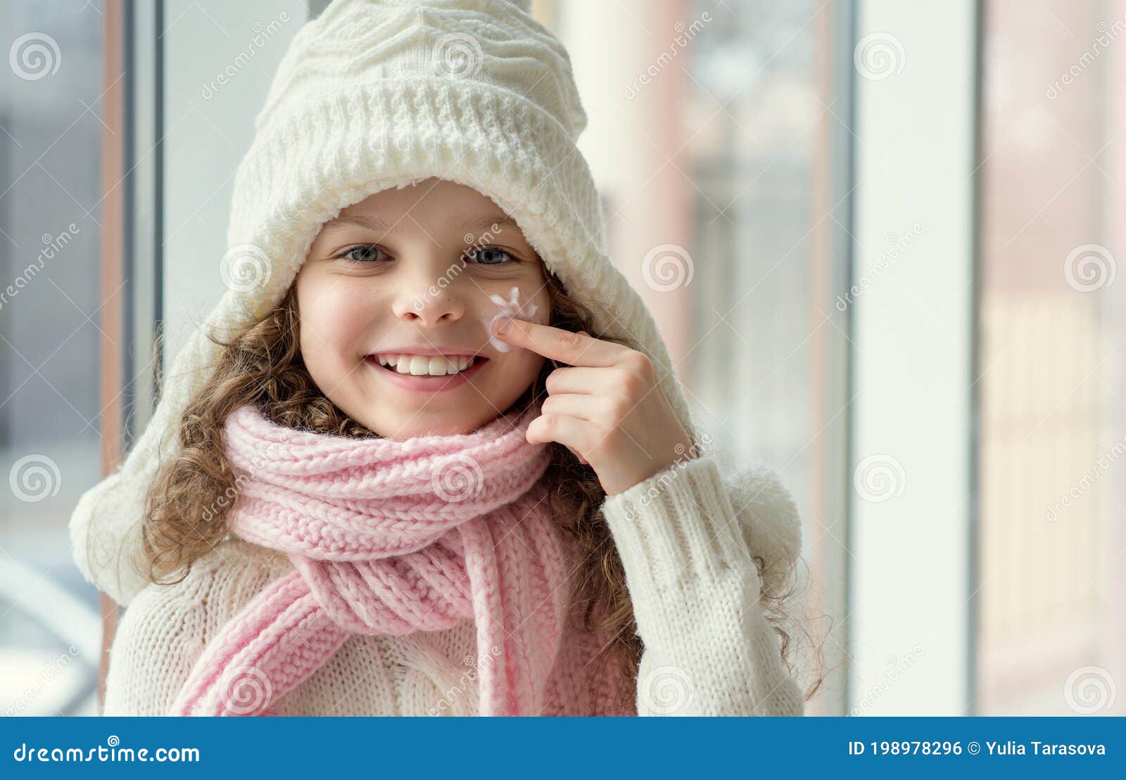 Cute Little Girl Applying Protecting Cream To Her Face. Winter Skin ...