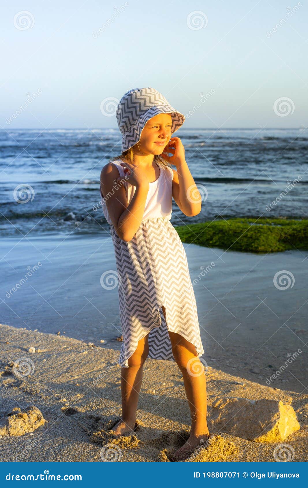 Cute Little Girl on the Beach. Caucasian Girl Wearing Dress and Hat ...