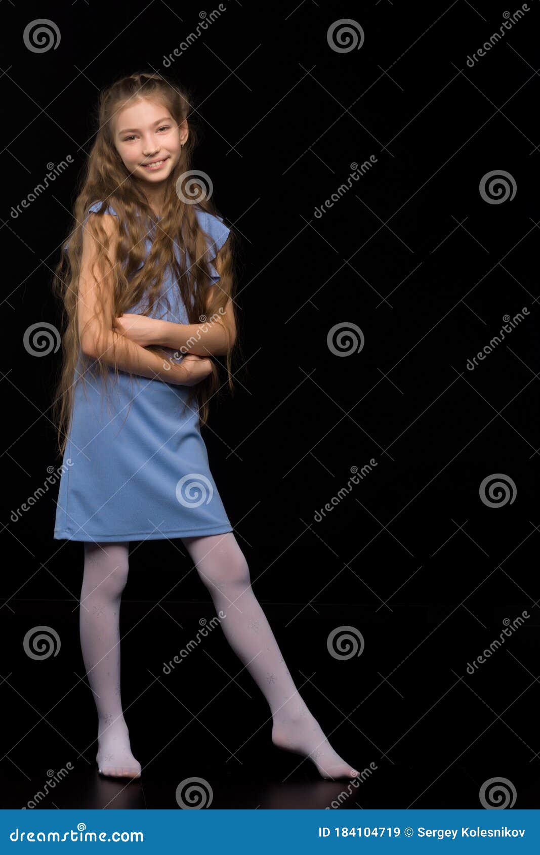 Cute Little Girl in a Beautiful Dress on a Black Background. Stock ...