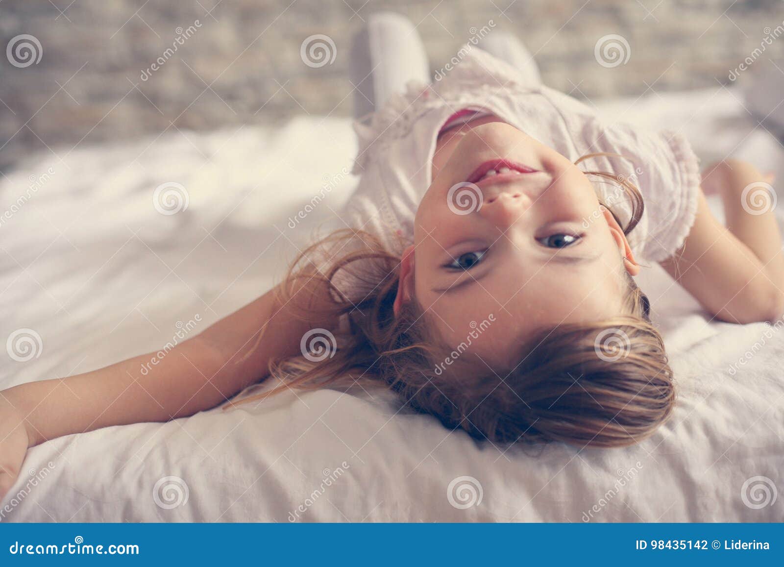 Cute little girl in bed. stock photo. Image of horizontal 98435142