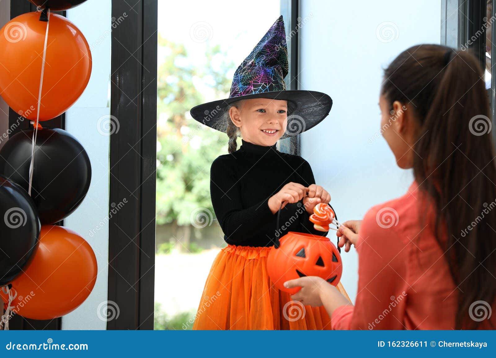 Cute Little Girl Dressed As Witch Trick-or-treating. Halloween ...