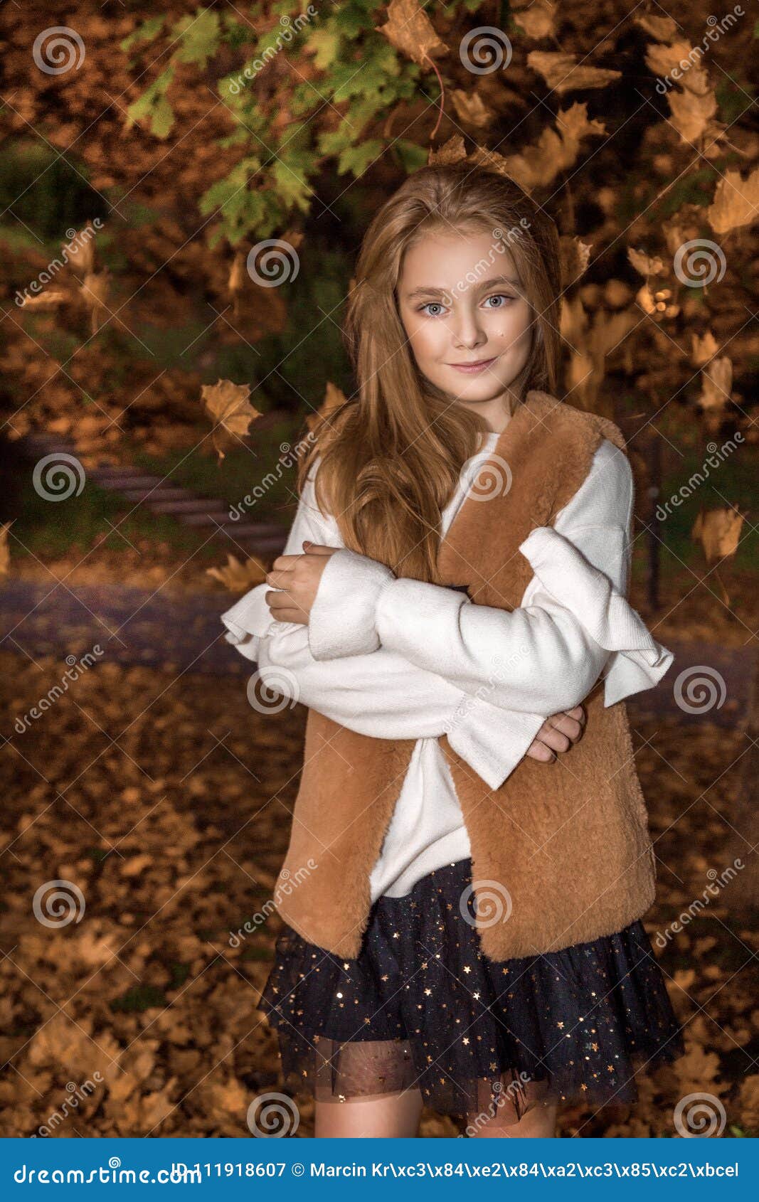 Cute Little Girl Dressed In Coat And Boots Sitting On Autumn Background ...