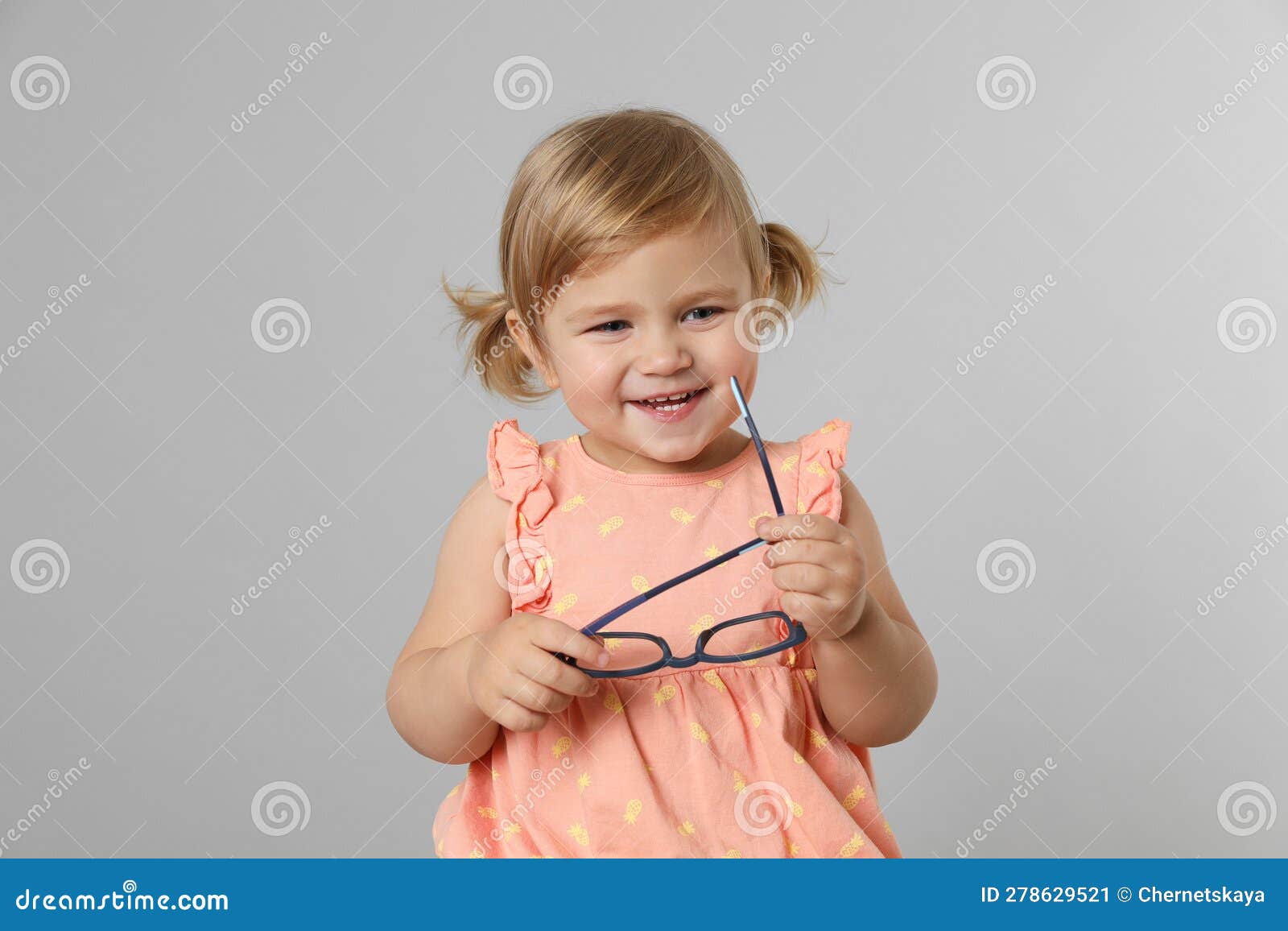 Cute Little Girl with Glasses on Light Grey Background Stock Image