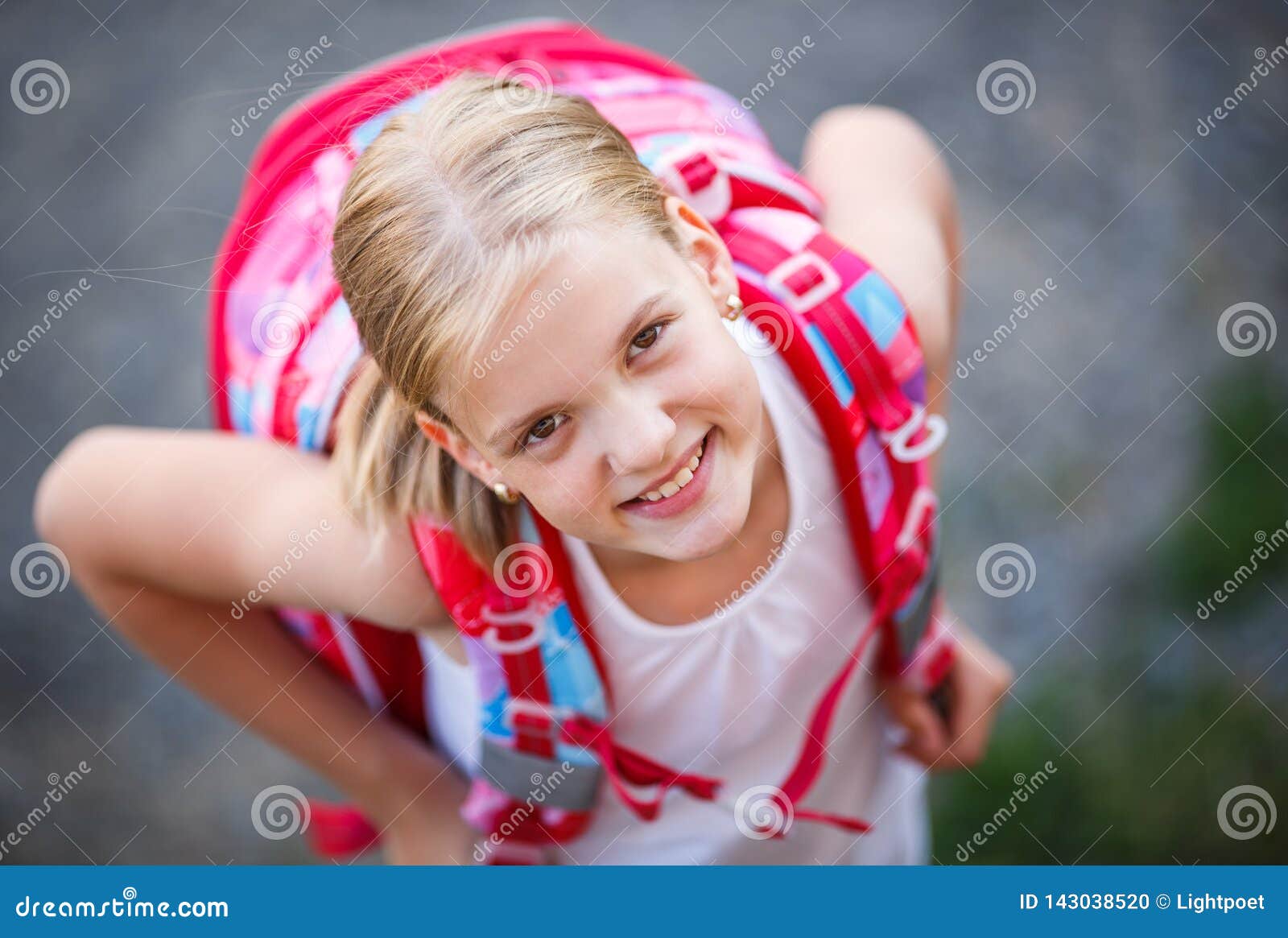 cute little girl going home from school with her backpack