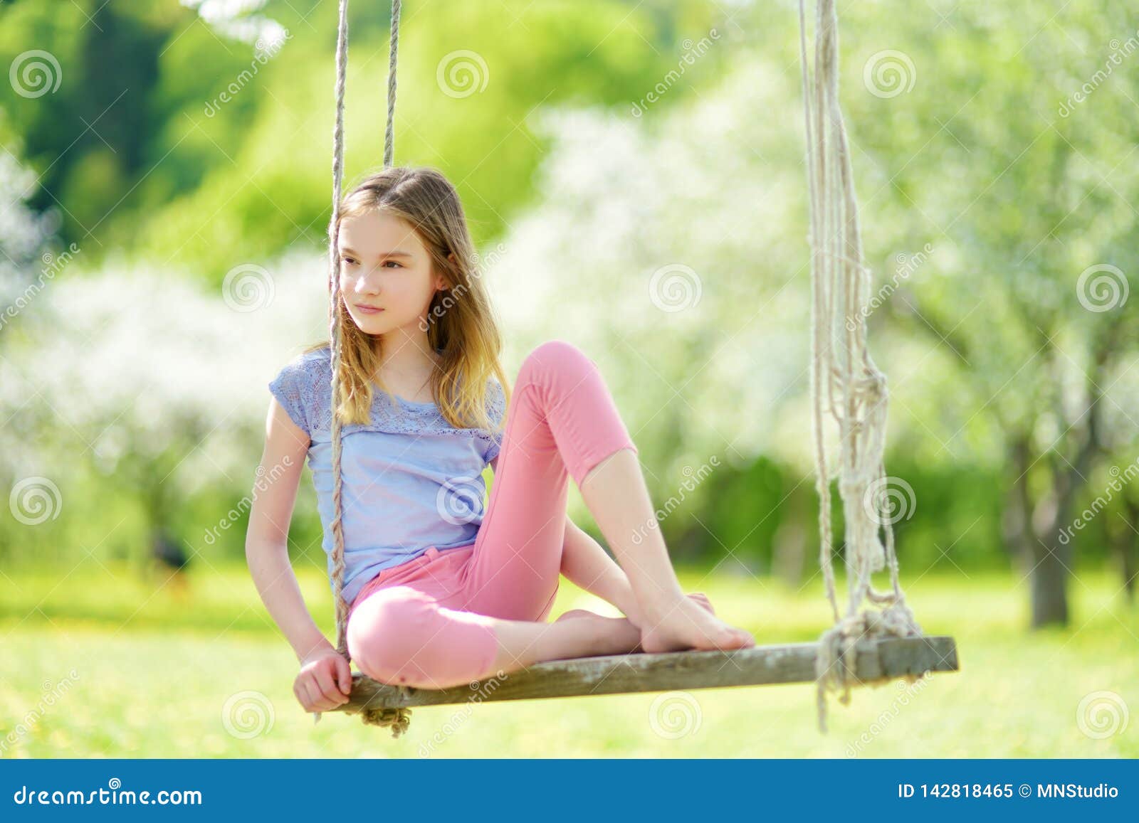 Cute Little Girl Having Fun on a Swing in Blossoming Old Apple Tree ...