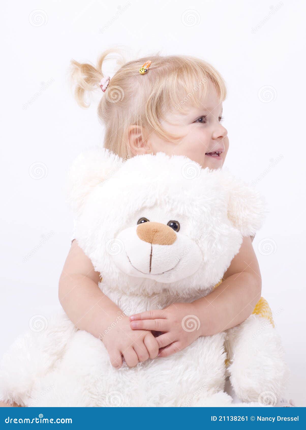 girl hugging a teddy bear
