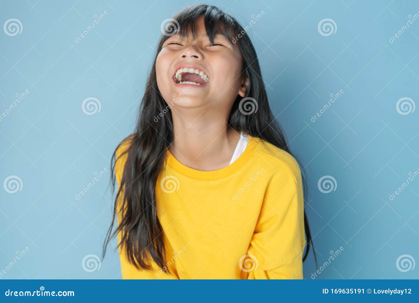 cute little girl laugh happy on blue