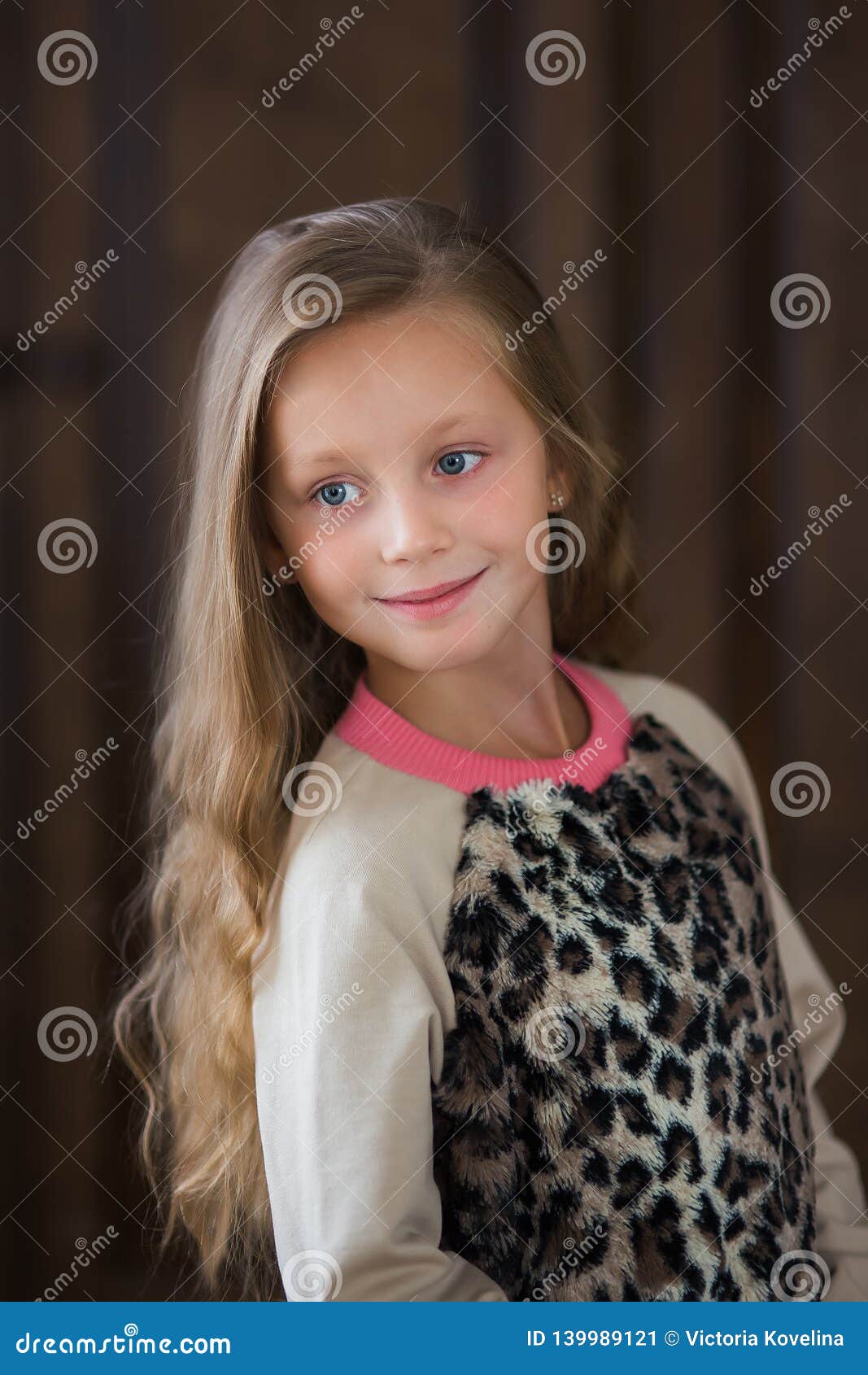 Cute Little Girl with Long Hair on a Brown Background Close-up Stock ...