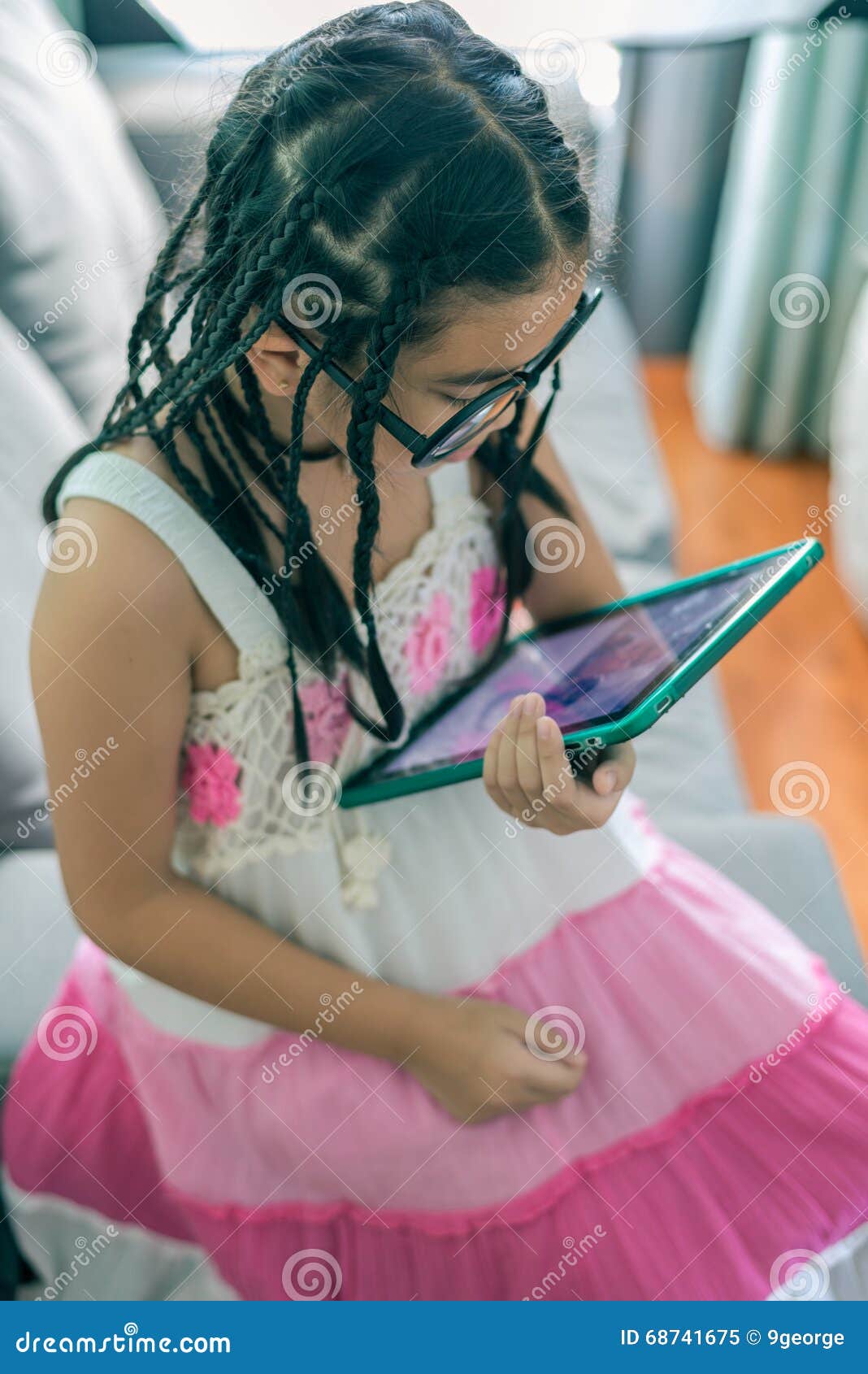 Cute Little Girl Playing With Computer At Home Laying On