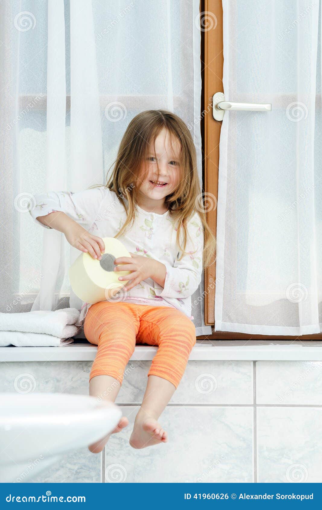 Cute Little Girl Playing With Toilet Paper Roll Stock Photo