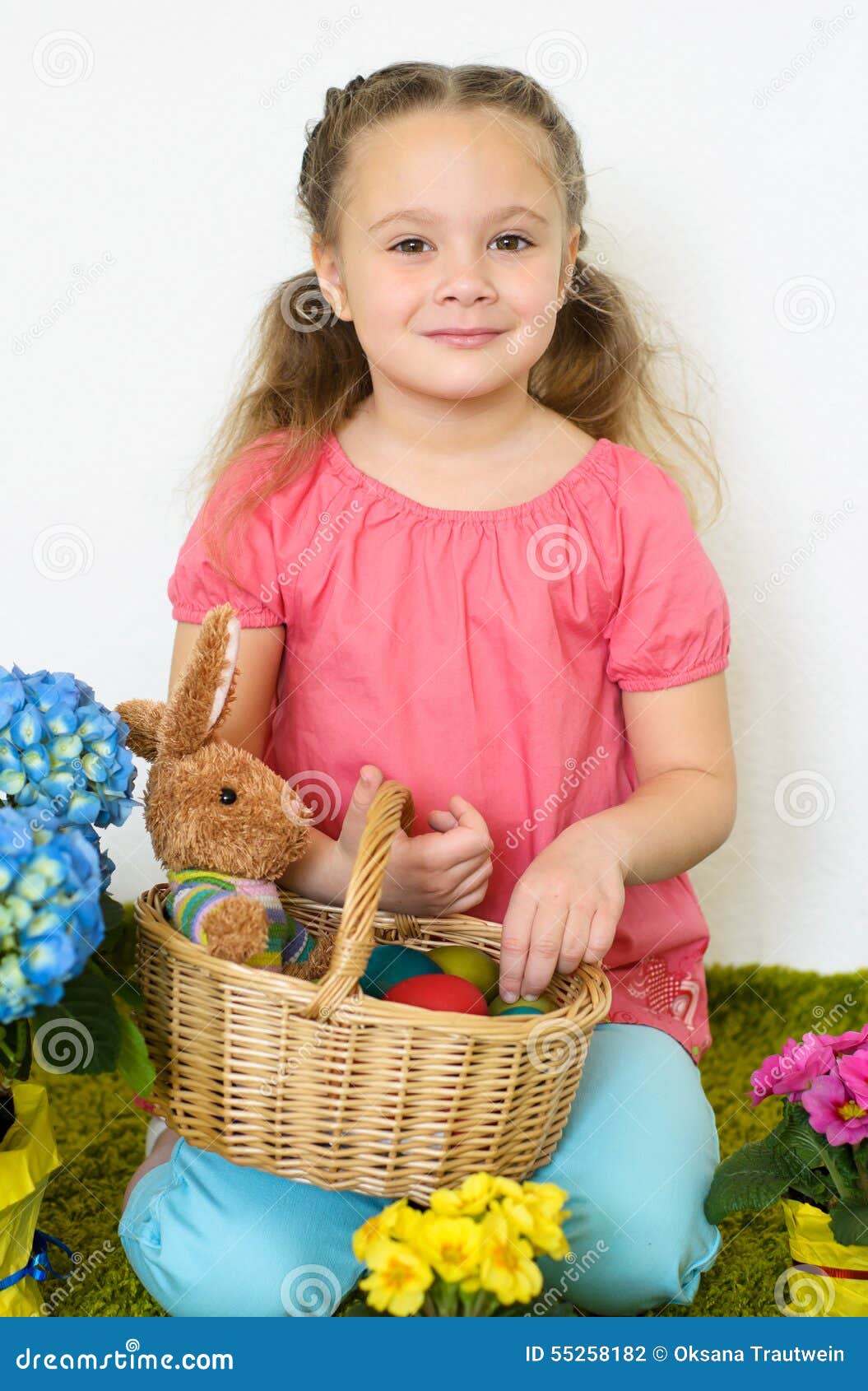 Cute Little Girl Plays with a Basket of Easter Eggs Stock Photo Image