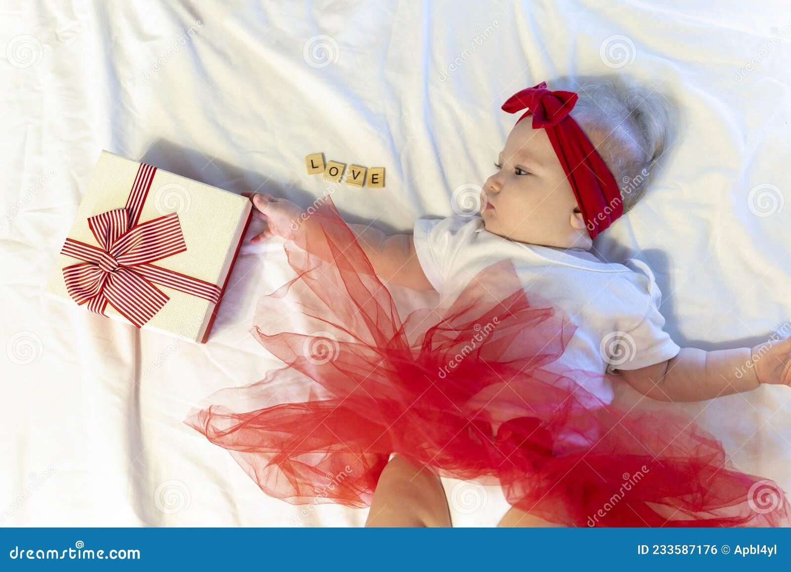 Cute Little Girl in Red Skirt Bow. Child Takes Gift. Love Lettering. Funny Kid Turns Over. 6 Months Old Baby Stock Photo - Image of concept, birthday: 233587176 Cute Little Girl in Red Skirt Bow. Child Takes Gift. Love Lettering. Funny Kid Turns Over. 6 Months Old Baby Stock Photo - Image of concept, birthday: 233587176