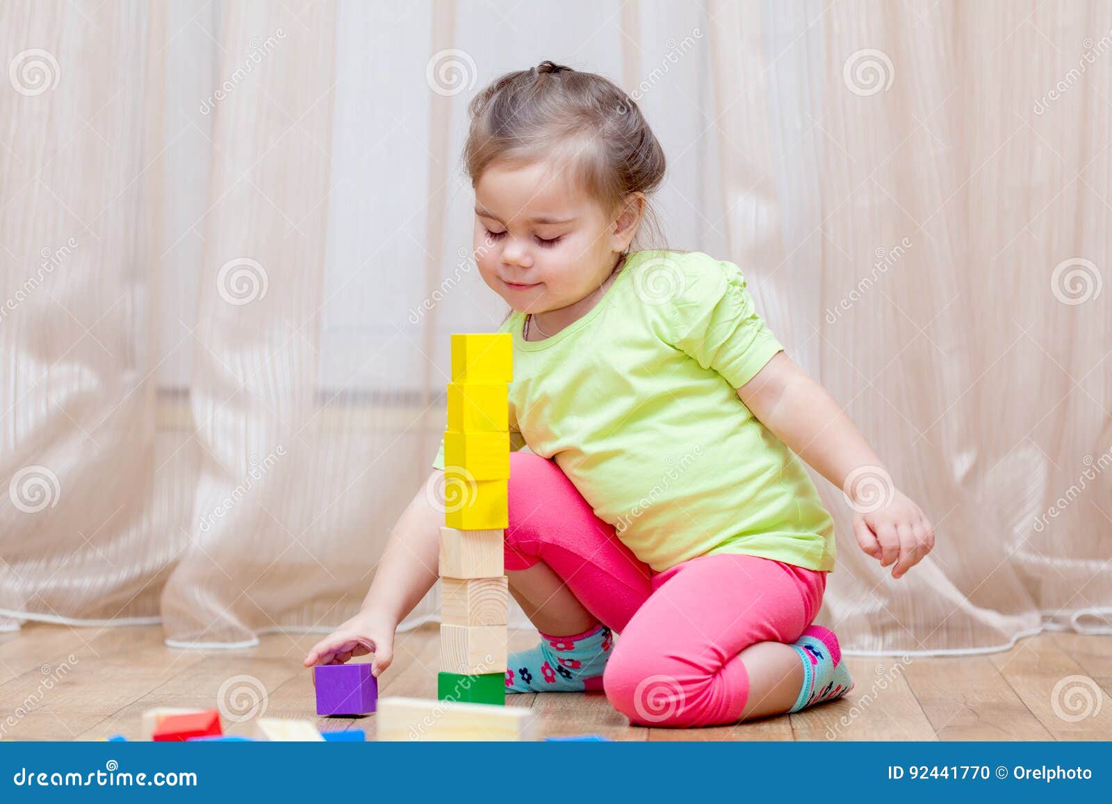 Cute Little Girl Sitting on the Floor and Playing with Building Stock ...