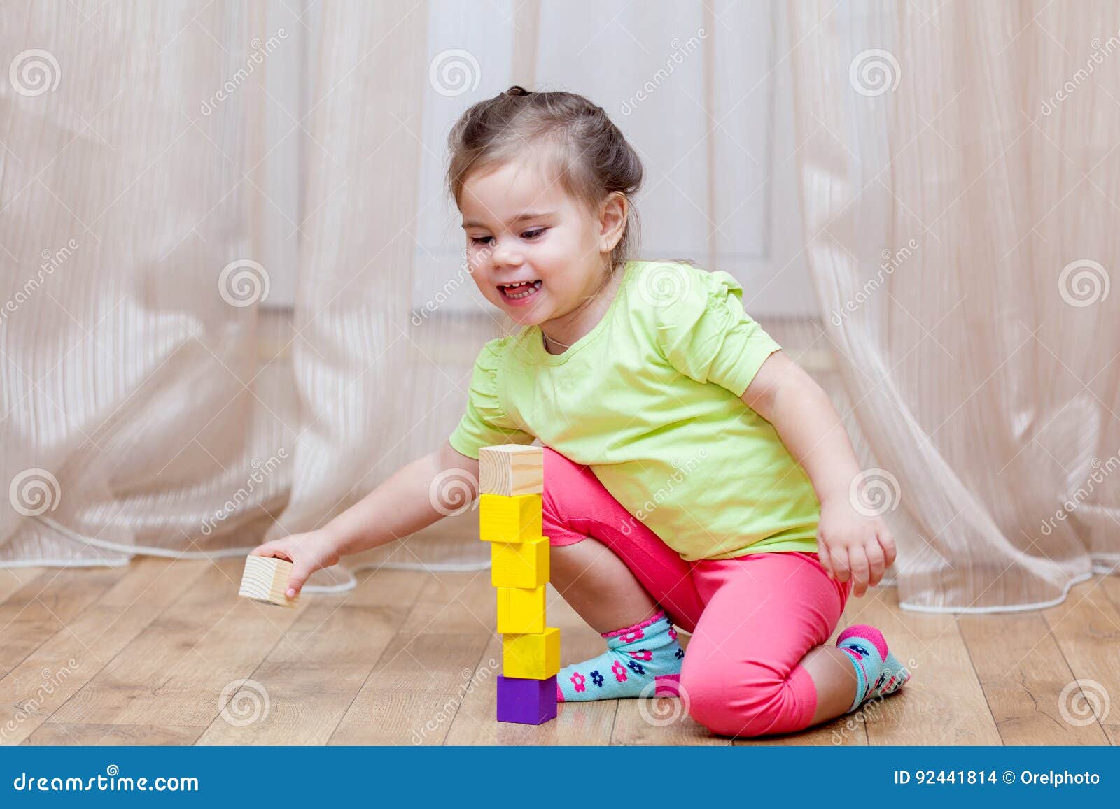 Cute Little Girl Sitting on the Floor and Playing with Building Stock ...