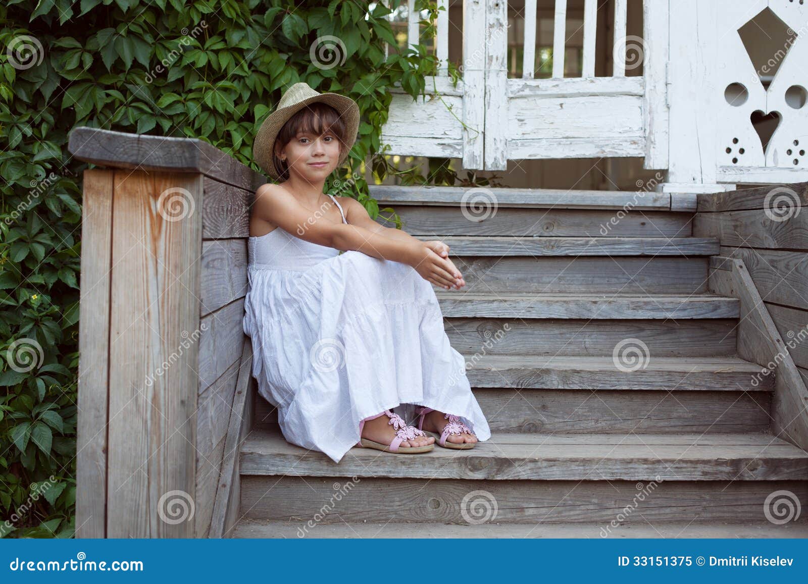 Beautiful little girl sitting in a lotus position on an exotic beach — Stock Photo © Lakschmi 