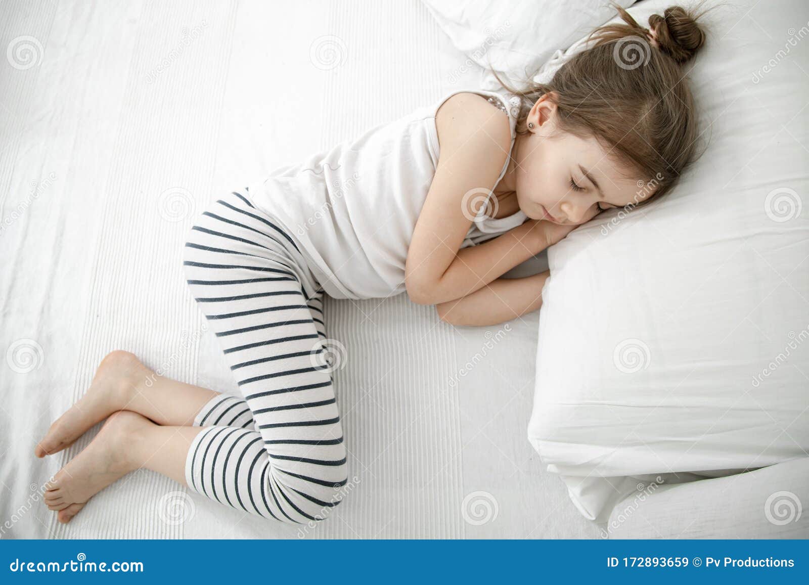 A Cute Little Girl is Sleeping in a White Bed Stock Image - Image of ...