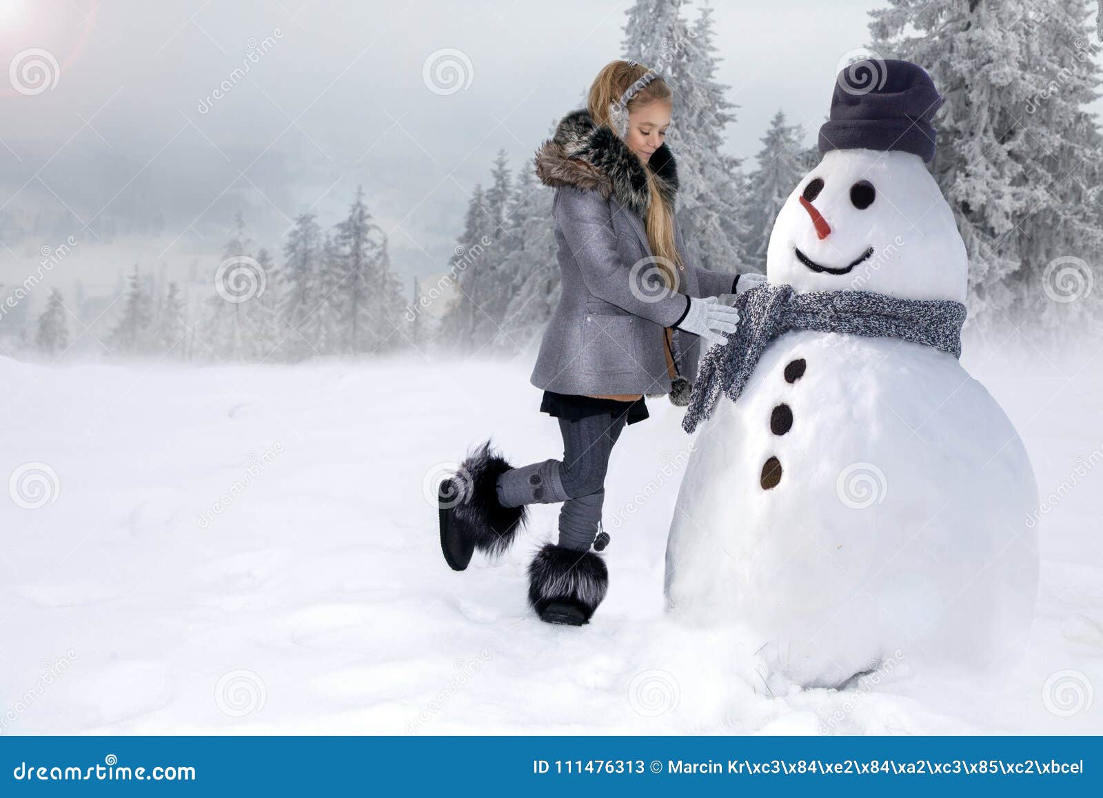 Cute Little Girl, Standing on the Snow and Makes a Snowman with