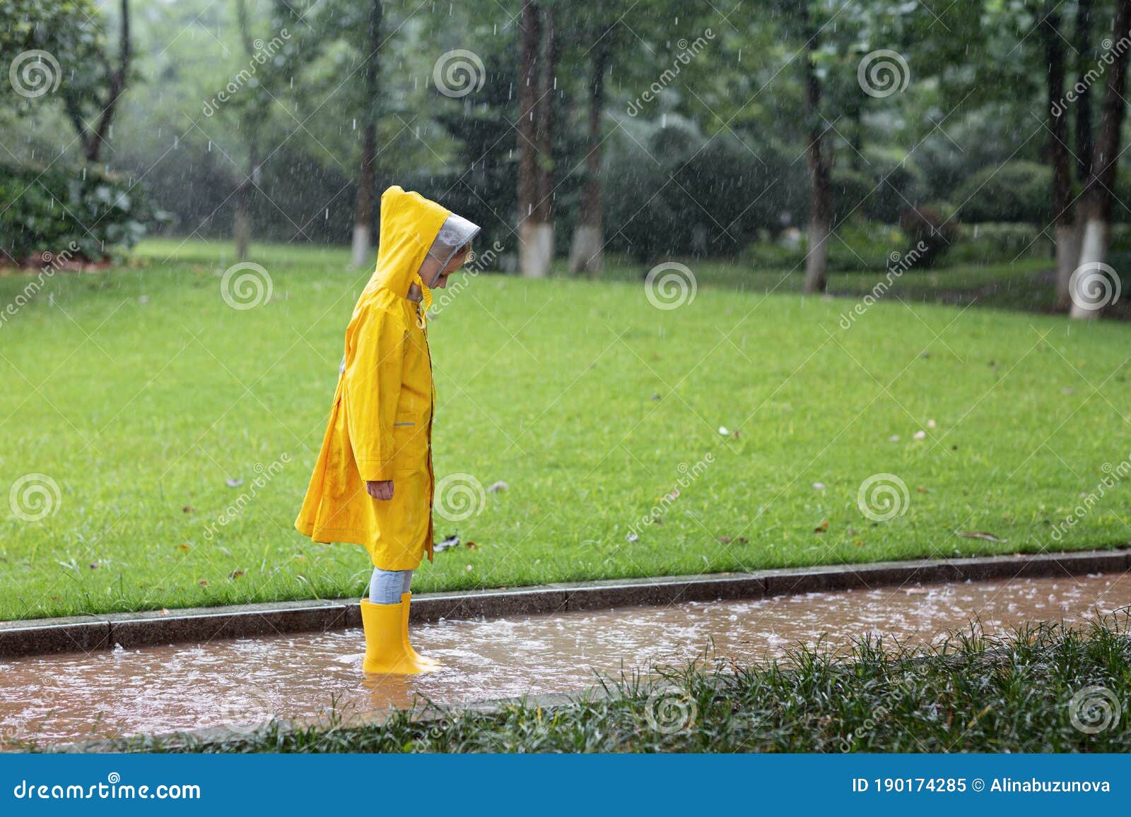 Cute Little Girl In Yellow Raincoat And Rubber Boots Walking Outdoor During  Rain. Bad Weather, Summer Tropical Storm, Autumn Stock Image - Image of  messy, happiness: 190174285