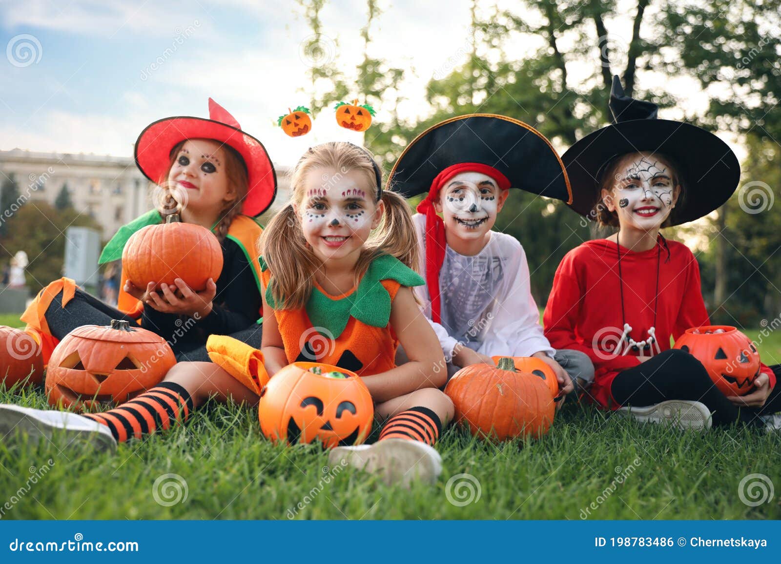 Cute Little Kids with Pumpkins Wearing Halloween Costumes in Park Stock ...