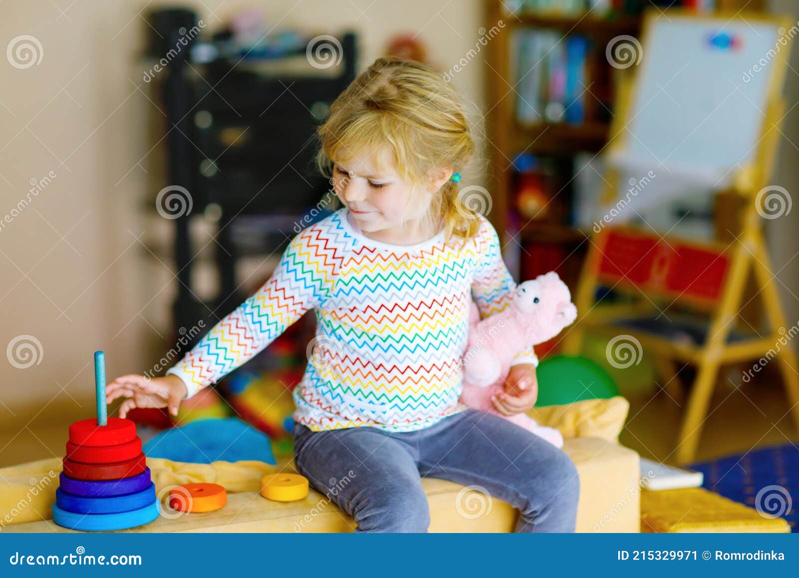 Cute Little Toddler Girl Playing Alone with Colorful Wooden Rainbow ...