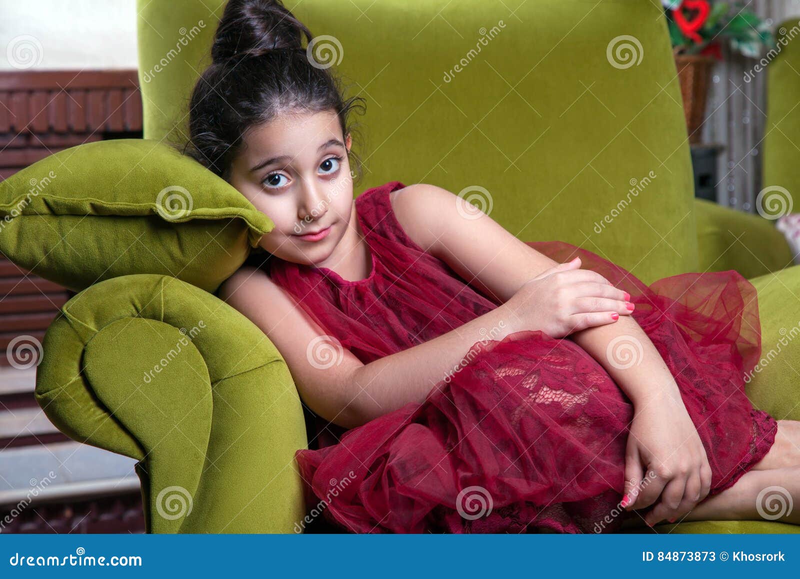 Cute Lovlely Middle Eastern Girl With Dark Red Dress And Collected Hair Posing And Liying On