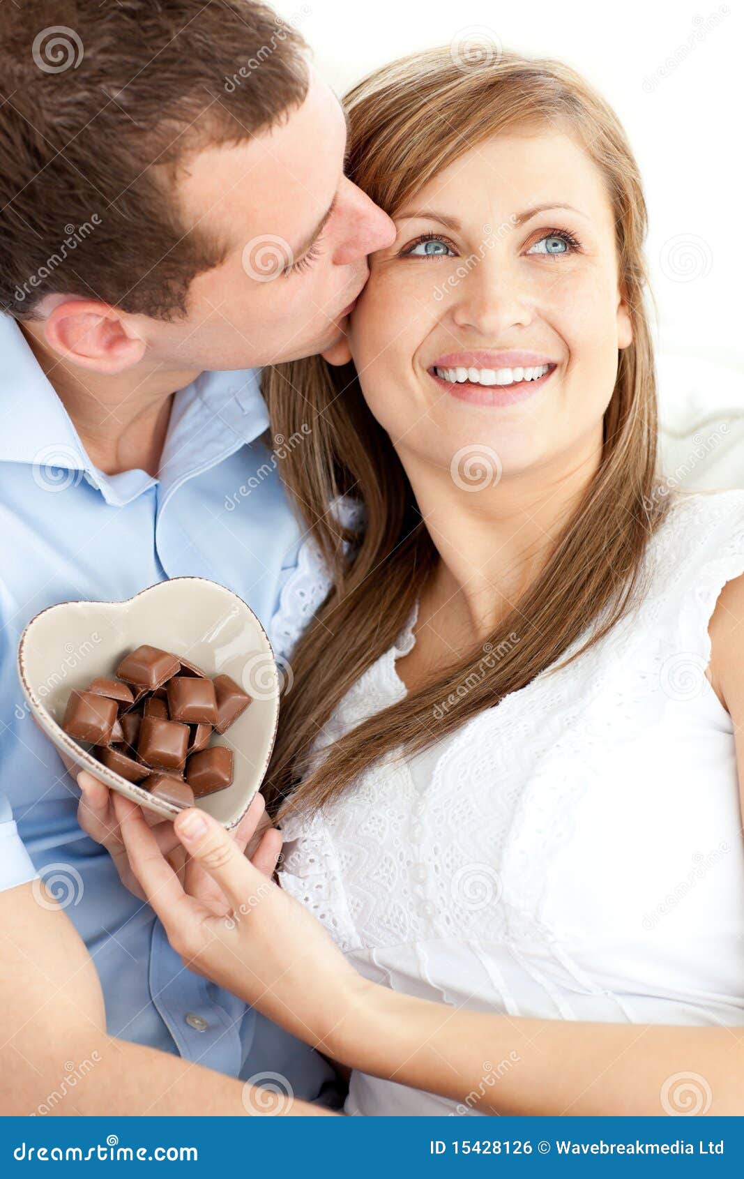 Cute Man Kissing His Girlfriend Holding Chocolates Stock Photo Image