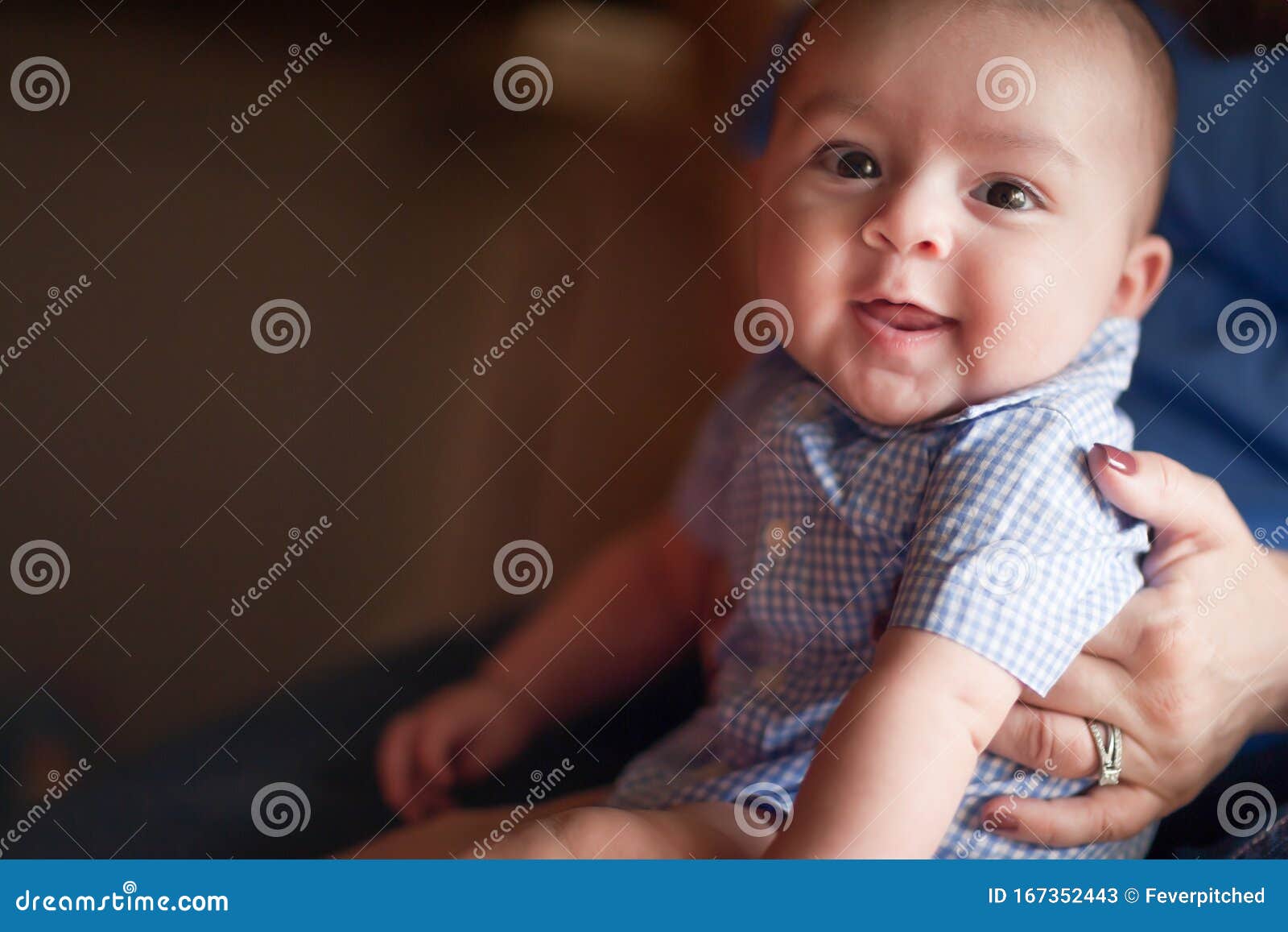 cute mixed race infant having fun with his parents