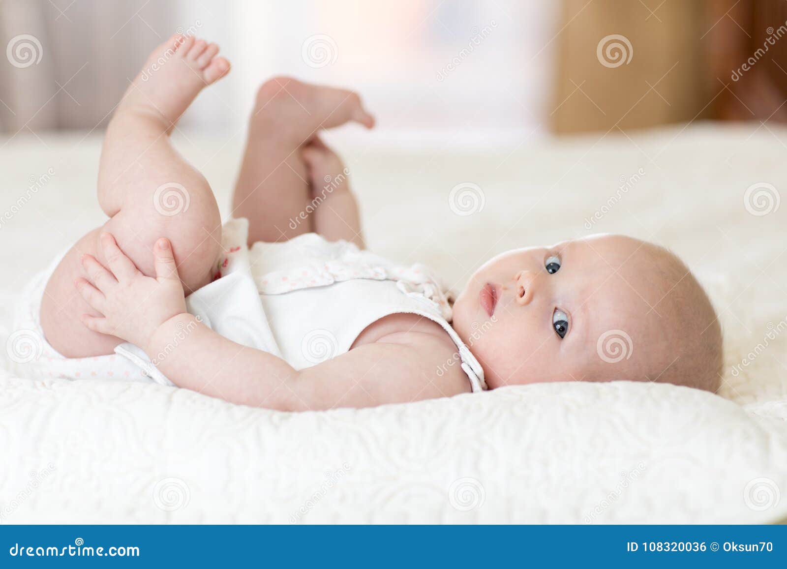 Cute 4 Months Baby Lying Down On Bed Stock Photo - Image ...