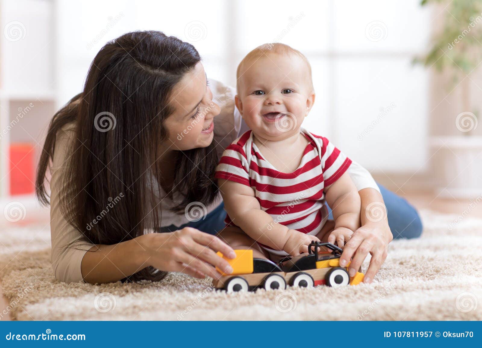 Cute Mother And Child Boy Play Together With Toys Indoors At Home Stock