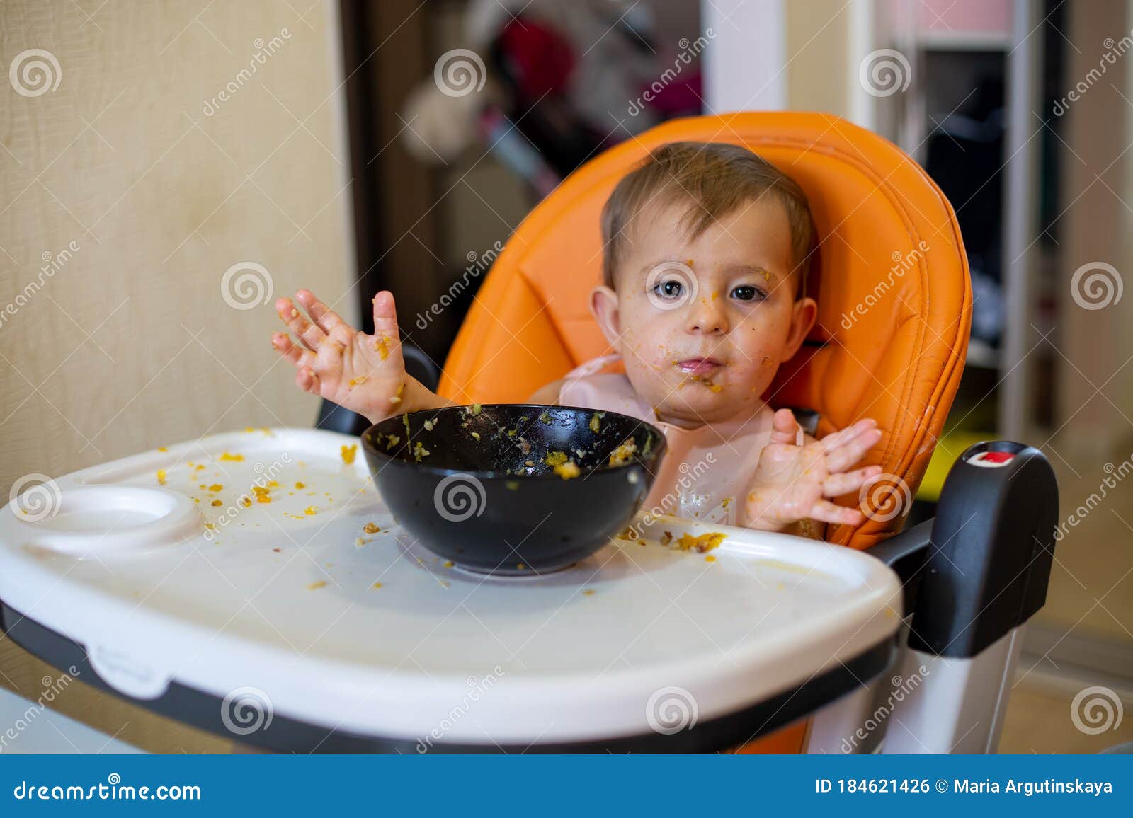 Cute One Year Old Baby Girl In An Orange Child Seat In ...