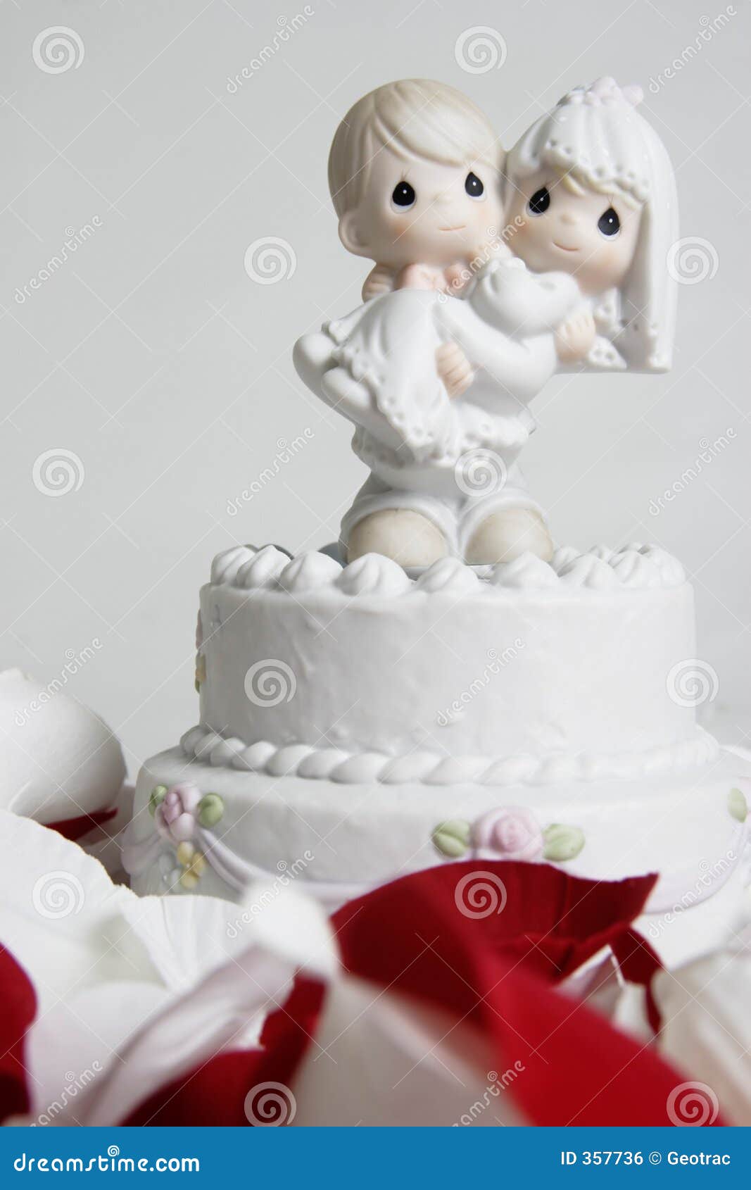 Cute Ornament of Groom Carrying Bride on Top of Wedding Cake Stock