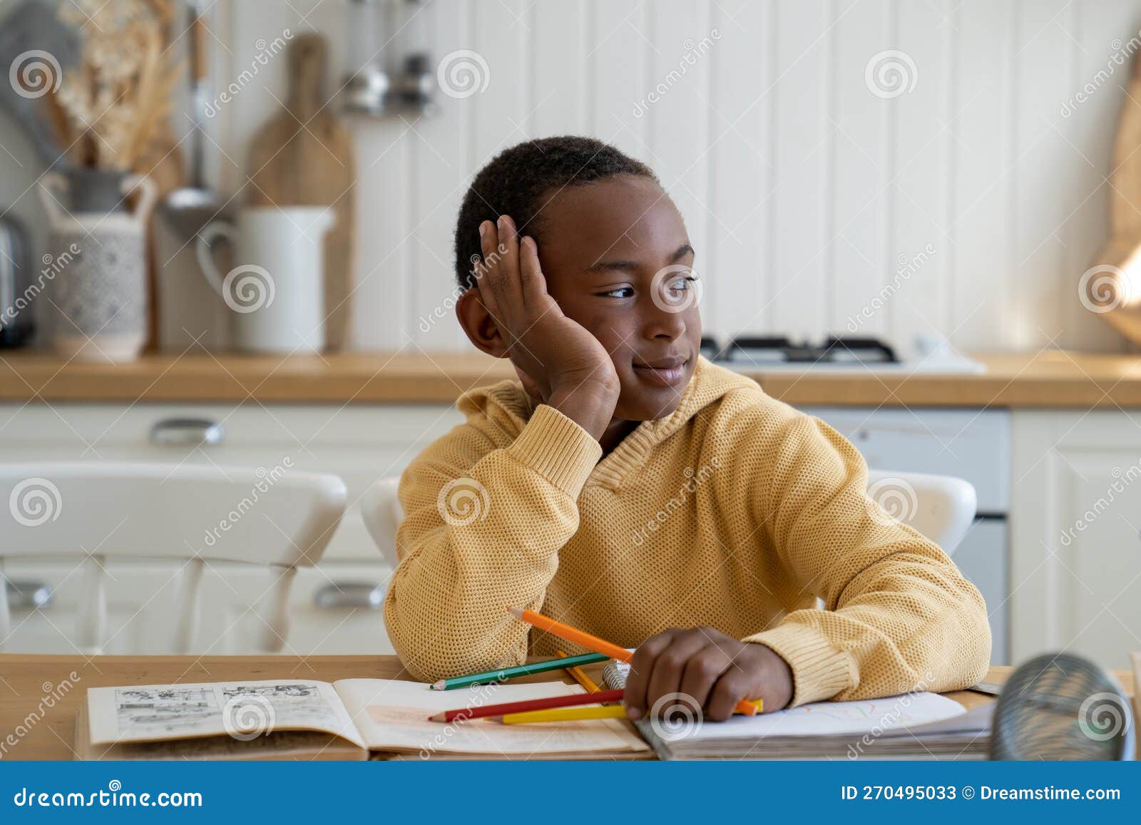 cute pensive biracial child boy look side at window distracted from study dream about computer game