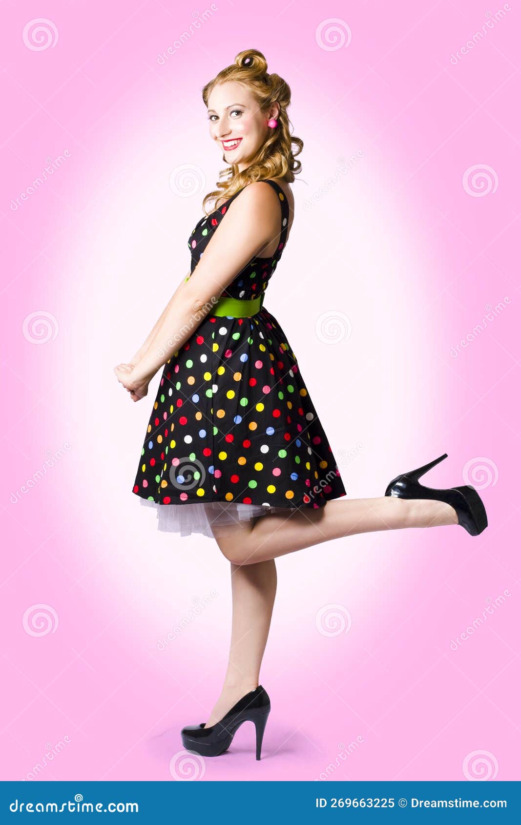 Female woman dressed in a rockabilly fashion posing next to a