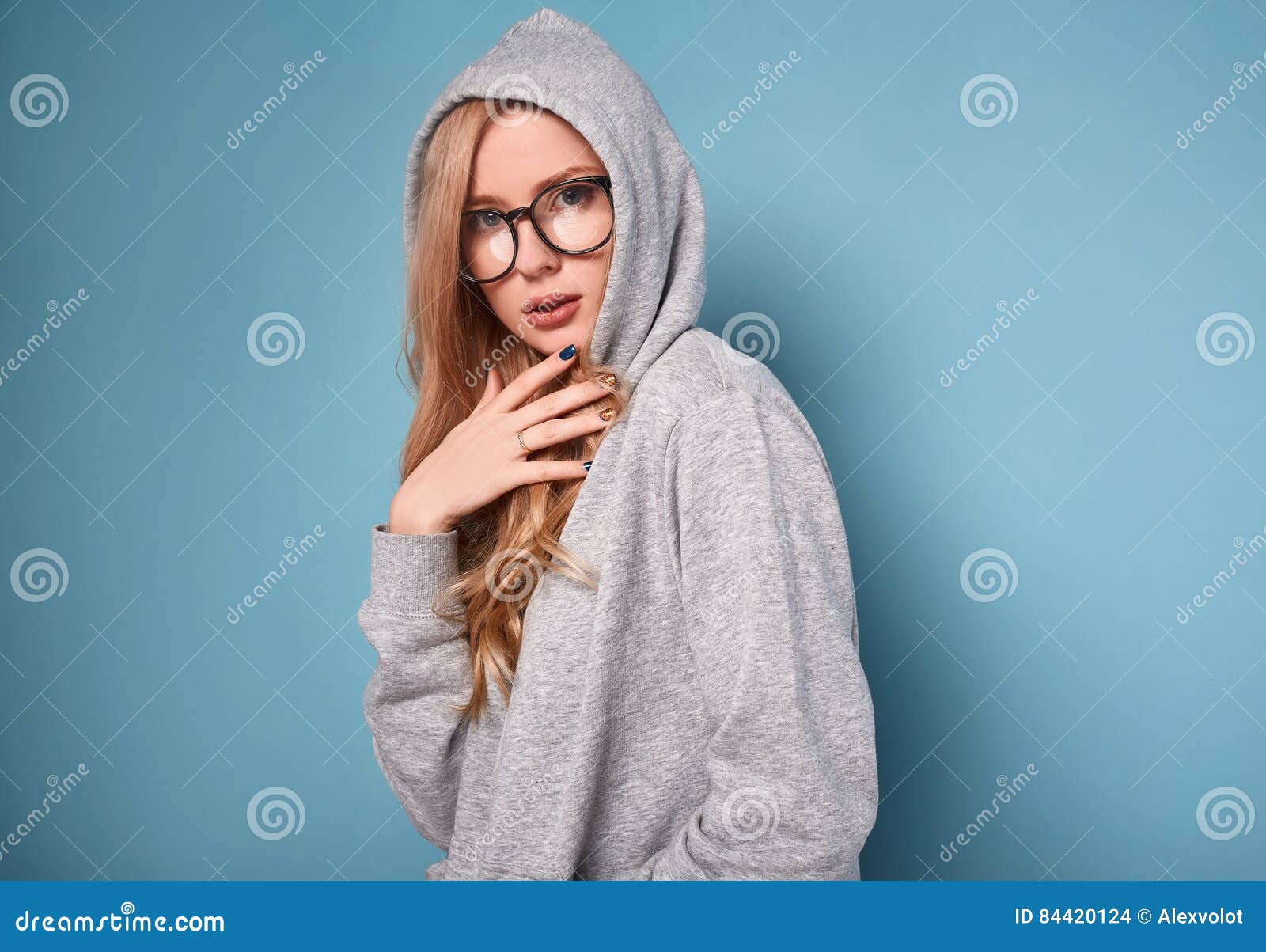 Cute Positive Blonde Woman in Gray Hoodie and Glasses Stock Photo ...