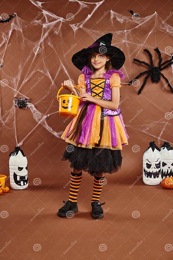 Cute Preteen in Witch Hat Holds Stock Photo Image of child, girl